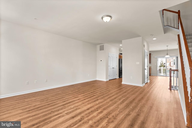 unfurnished living room with light hardwood / wood-style floors