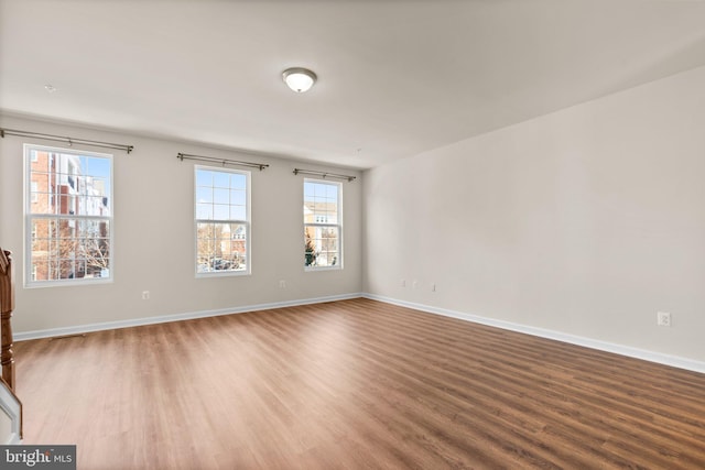 unfurnished room with hardwood / wood-style floors