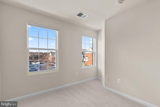 unfurnished room with light colored carpet