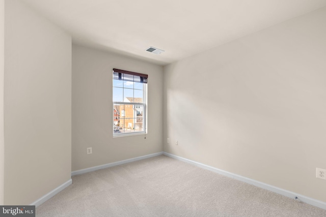 empty room featuring light carpet