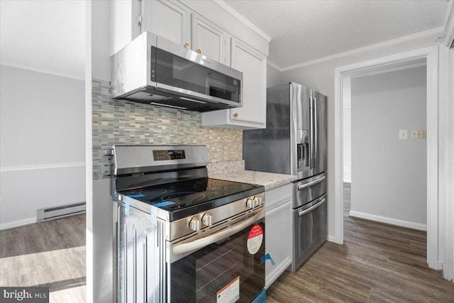 kitchen with white cabinetry, decorative backsplash, baseboard heating, stainless steel appliances, and crown molding