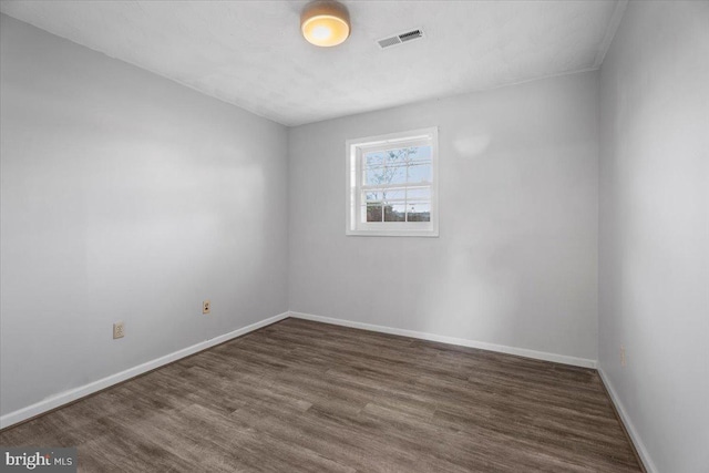 unfurnished room with dark hardwood / wood-style flooring