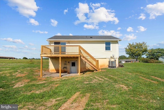rear view of house with a wooden deck and a yard