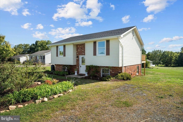 raised ranch with a front yard