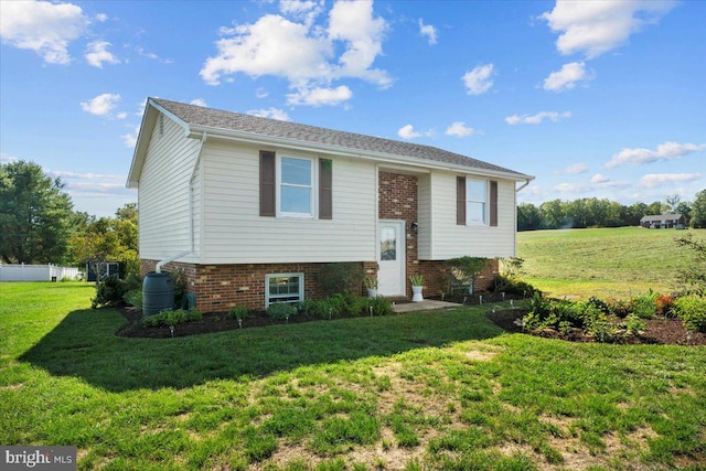 raised ranch with a front yard