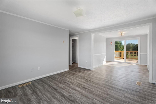 spare room with crown molding, a textured ceiling, and dark hardwood / wood-style flooring