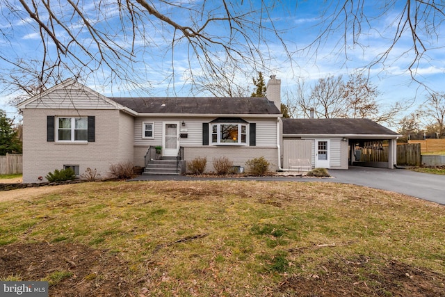 ranch-style house featuring a carport and a front yard