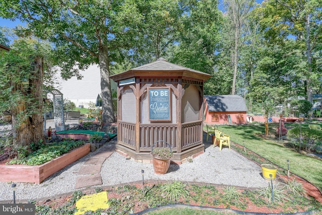 exterior space featuring a front lawn and a storage unit