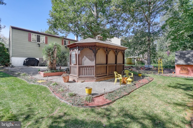 back of house featuring a gazebo, a sunroom, and a lawn