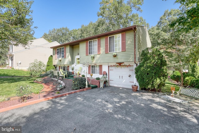 bi-level home with a garage and a front yard