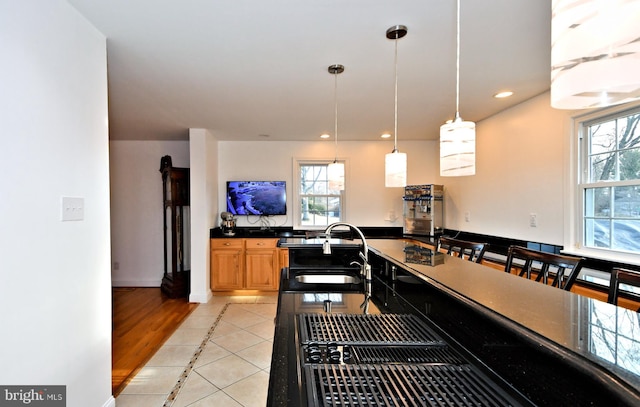 kitchen featuring pendant lighting, sink, and light tile patterned floors