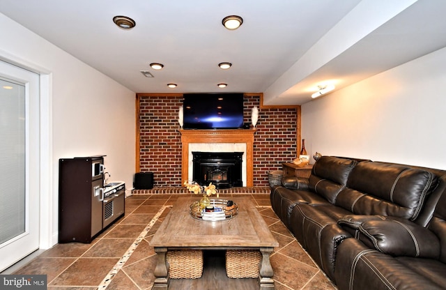 living room featuring a brick fireplace