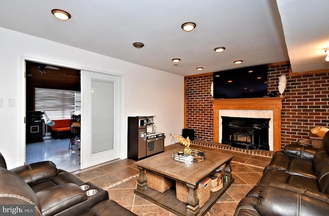 tiled living room featuring brick wall and a fireplace