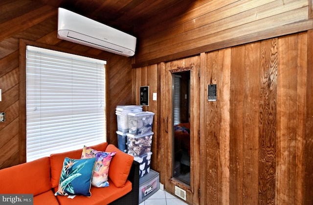 interior space with tile patterned floors, wooden walls, and a wall unit AC