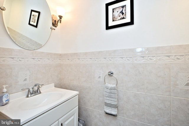 bathroom featuring vanity and tile walls