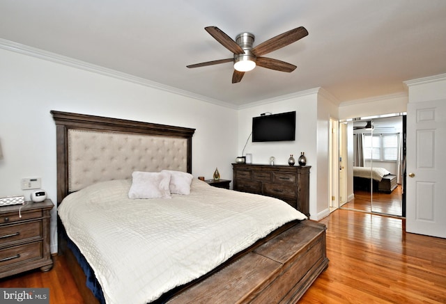 bedroom with crown molding, hardwood / wood-style floors, and ceiling fan