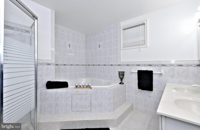 bathroom featuring tile walls, vanity, tile patterned flooring, and separate shower and tub