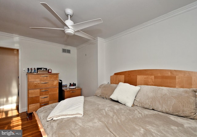 bedroom featuring ornamental molding, ceiling fan, and dark hardwood / wood-style flooring