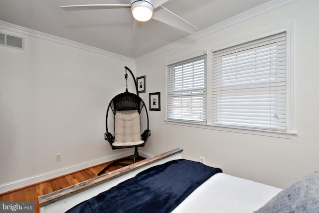 bedroom with crown molding, hardwood / wood-style floors, and ceiling fan