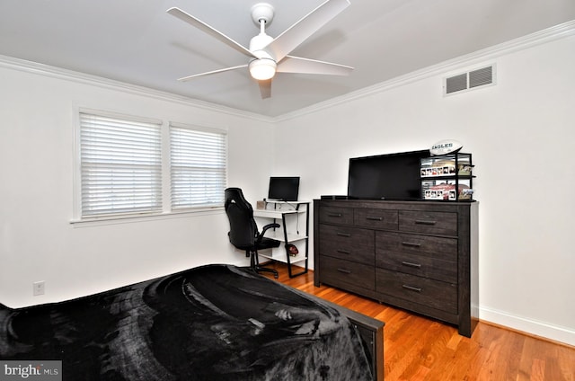 bedroom with ceiling fan, ornamental molding, and light hardwood / wood-style flooring