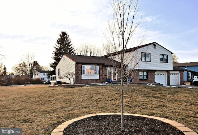 split level home with a garage and a front yard