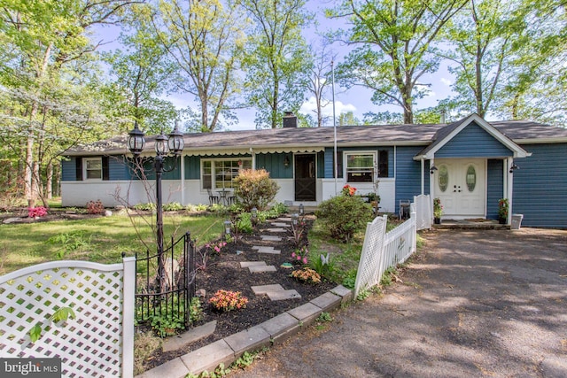 432 Swartley Rd, Hatfield, PA 19440 - single story home featuring board and batten siding, fence, a chimney, and a front yard