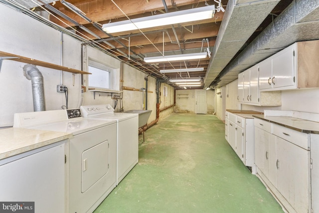 basement with independent washer and dryer and sink