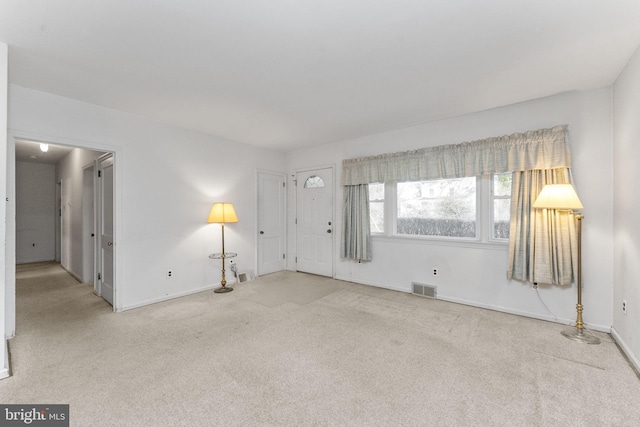 unfurnished room featuring light colored carpet