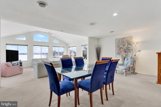 dining space featuring light carpet, lofted ceiling, and ceiling fan