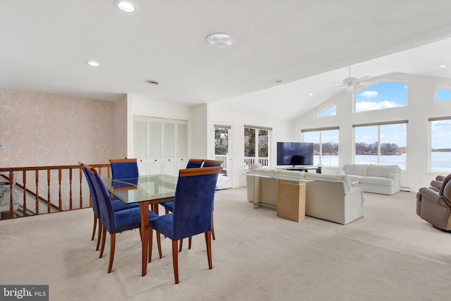 carpeted dining space featuring vaulted ceiling and ceiling fan