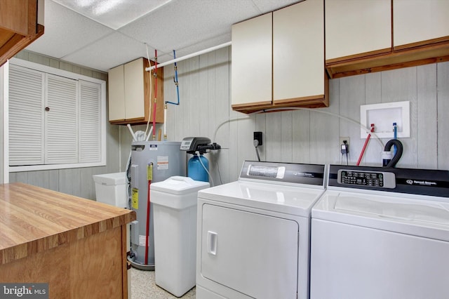 washroom featuring separate washer and dryer and cabinets