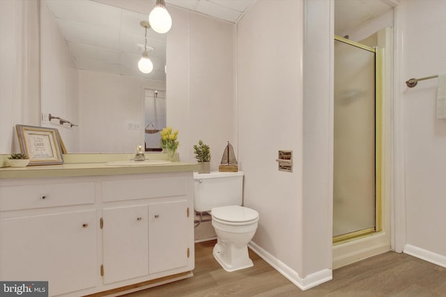 bathroom featuring vanity, hardwood / wood-style floors, toilet, and walk in shower