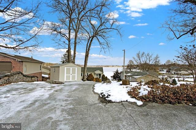 yard layered in snow with a storage unit