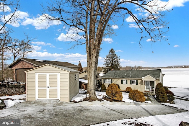 single story home featuring a storage shed