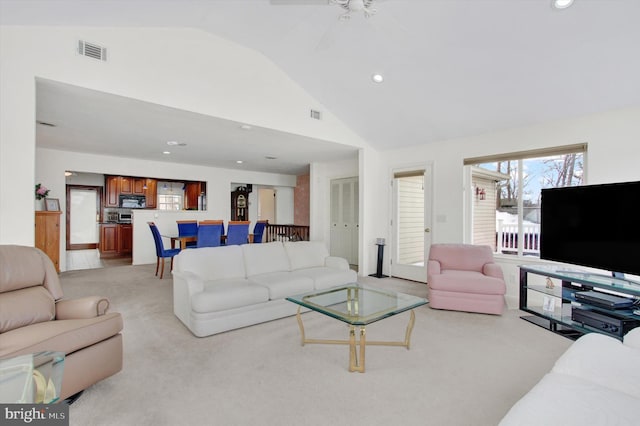 carpeted living room with vaulted ceiling and ceiling fan