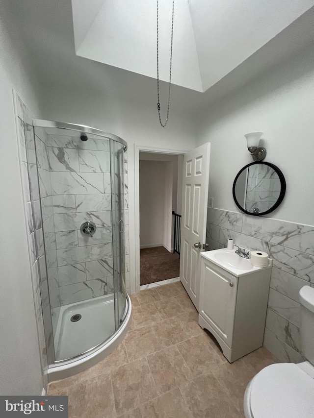 bathroom with lofted ceiling, tile walls, vanity, walk in shower, and toilet