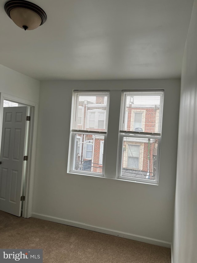 carpeted empty room featuring plenty of natural light