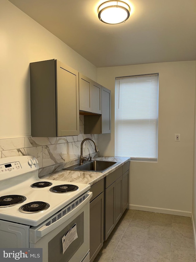 kitchen featuring gray cabinets, sink, decorative backsplash, light tile patterned floors, and electric range