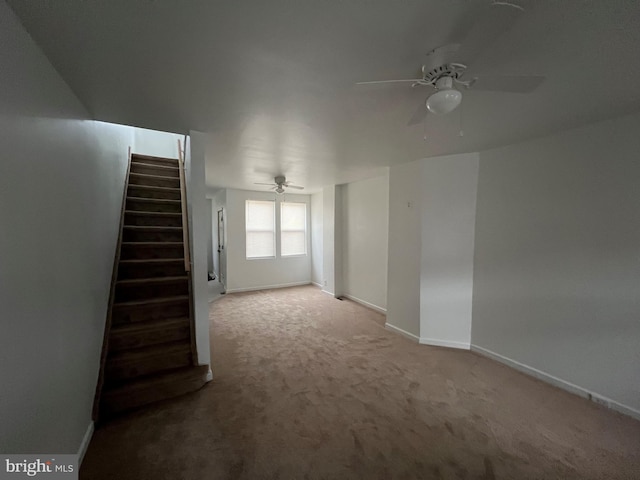 unfurnished room featuring ceiling fan and carpet flooring