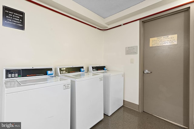 clothes washing area with washer and clothes dryer