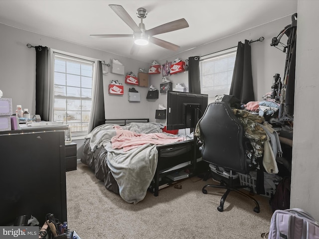 bedroom with light carpet and ceiling fan