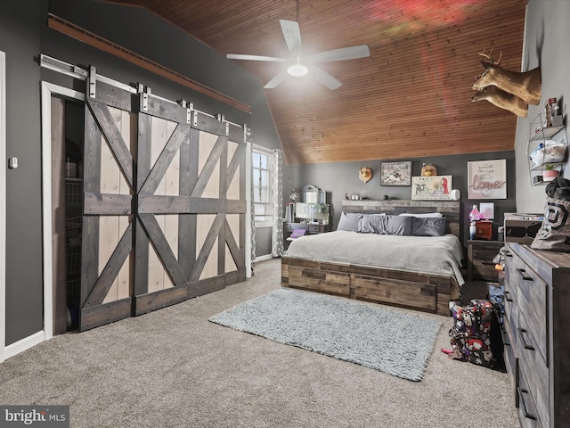 carpeted bedroom featuring vaulted ceiling, a barn door, wooden ceiling, and ceiling fan