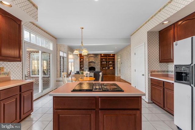 kitchen featuring black electric stovetop, white refrigerator with ice dispenser, light countertops, and wallpapered walls