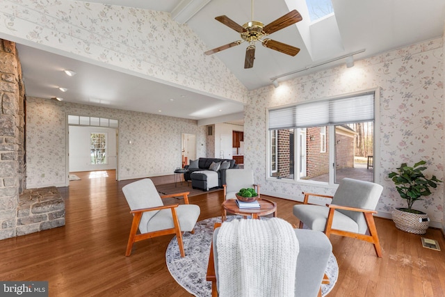 interior space with wallpapered walls, visible vents, and wood finished floors