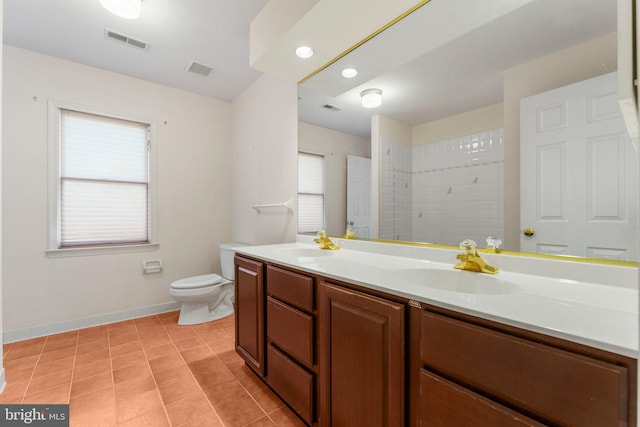 full bath with visible vents, a sink, toilet, and double vanity