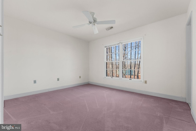 carpeted empty room featuring baseboards, visible vents, and ceiling fan