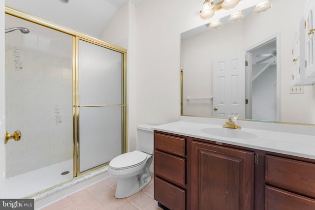 bathroom featuring toilet, a shower stall, vanity, and tile patterned floors