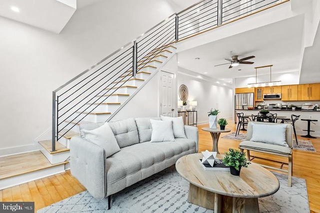 living room featuring ceiling fan and light wood-type flooring