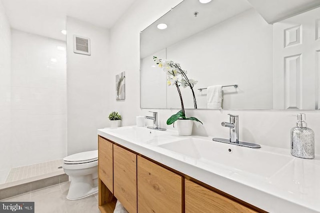 bathroom with vanity, a shower, tile patterned floors, and toilet