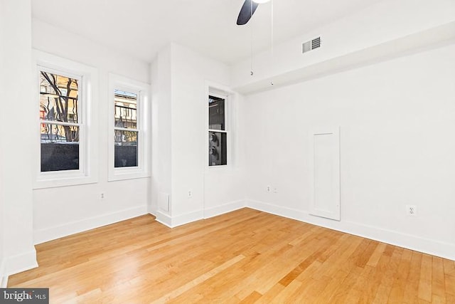 empty room with wood-type flooring and ceiling fan